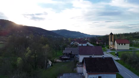 Aerial view of a forested landscape and a small village in spring