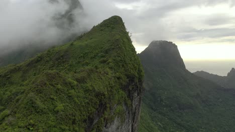 Aerial-flying-sideways-over-an-exuberant-mountain-ridge-with-a-dramatic-sky-on-background