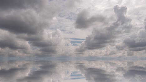 futuristic background consisting of time lapse clip of white fluffy clouds over blue sky and their reflection, video loop