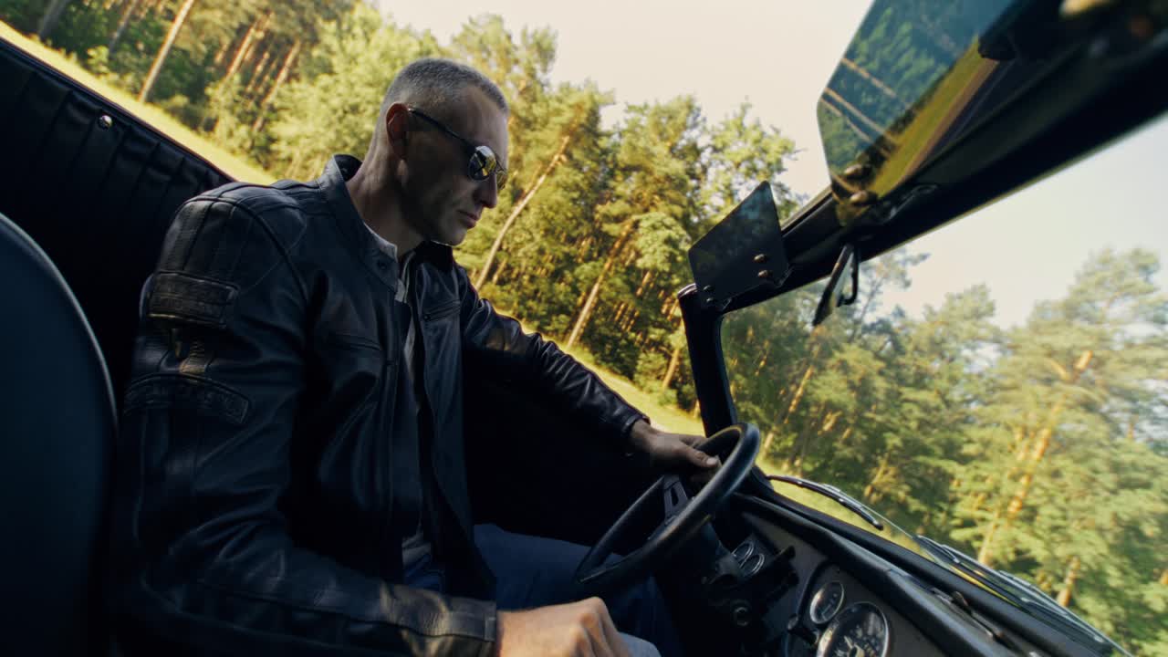 Man Driving a Classic Convertible