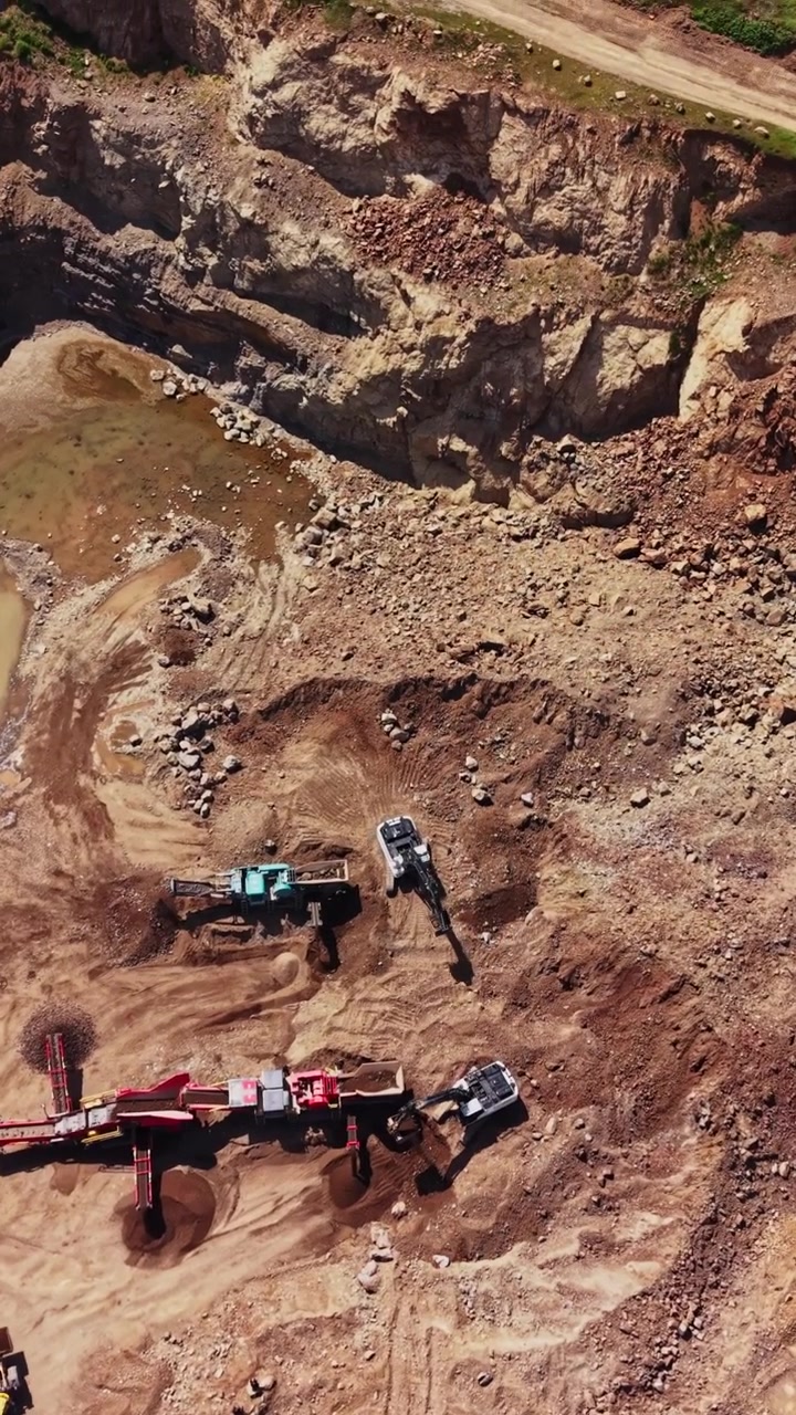 Construction work happens on a large mining site in a dry area