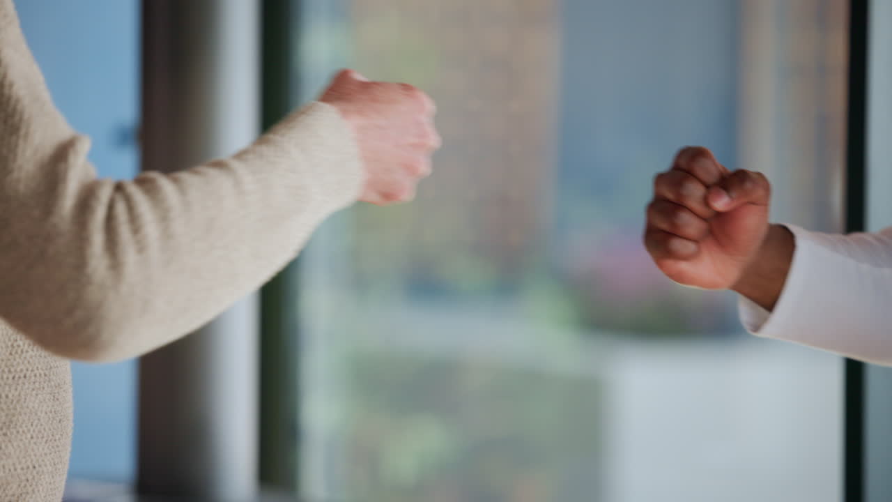 Close Up of Two People Performing a Fist Bump Greeting