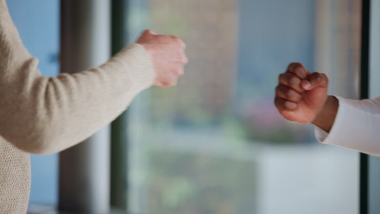 Close Up of Two People Performing a Fist Bump Greeting