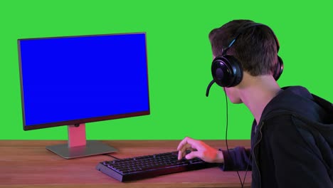 gamer talking about the game on the screen to camera on a green screen, chroma key