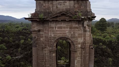 camera lowers smoothly, moving closer to the ruins of san juan parangaricutiro church