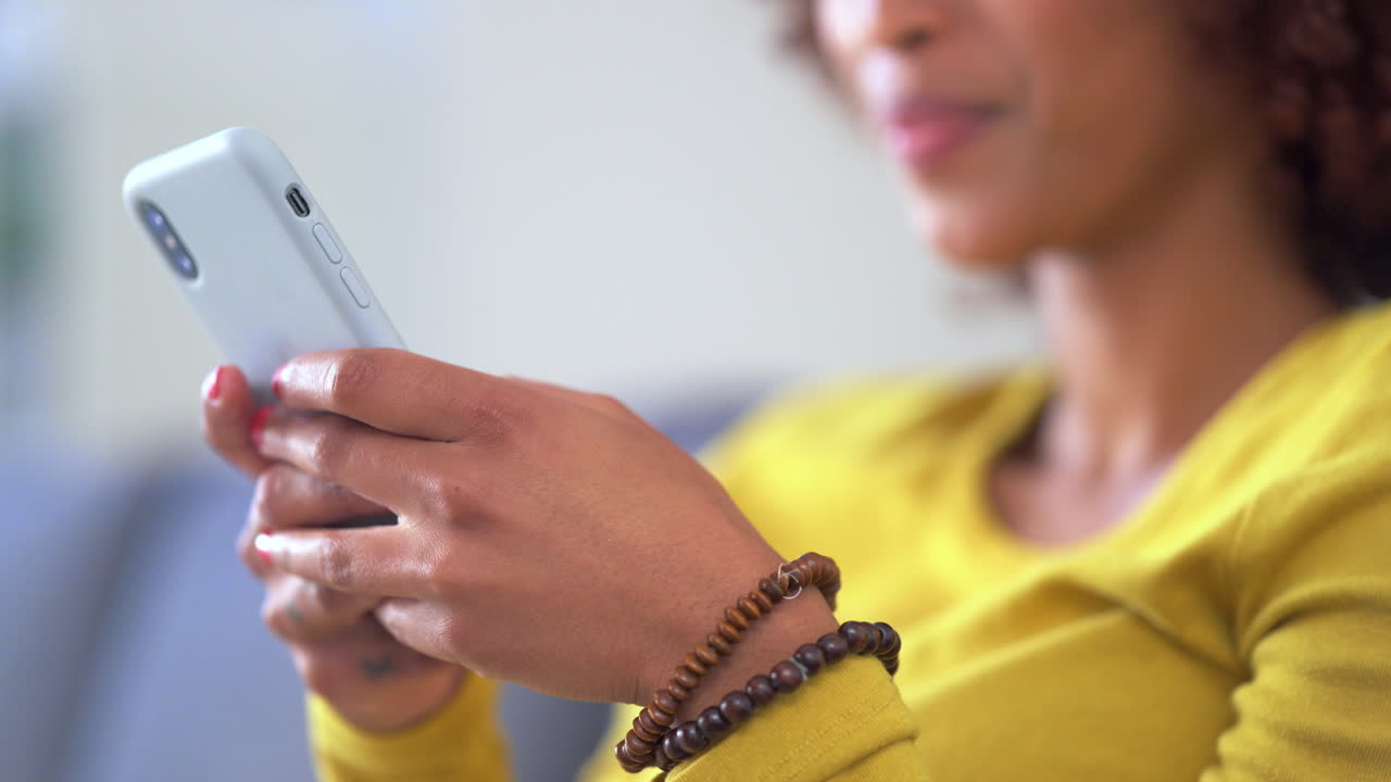 Hands typing message on phone