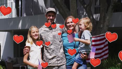 animación de los corazones sobre el soldado caucásico sonriente con la familia con banderas estadounidenses y abrazando