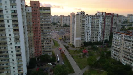 Aerial-view-in-between-old-soviet-architecture-buildings,-in-a-poor-ghetto-district-of-Kyiv,-during-sunset,-in-Kiev,-Ukraine---tracking,-drone-shot