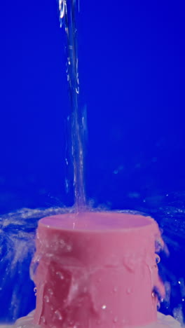 water splashing onto pink cylinder