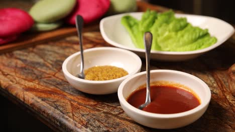 restaurant food preparation with sauces and salad