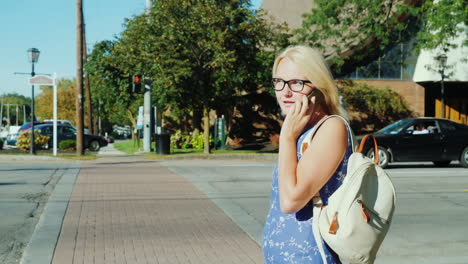 woman using phone at crosswalk