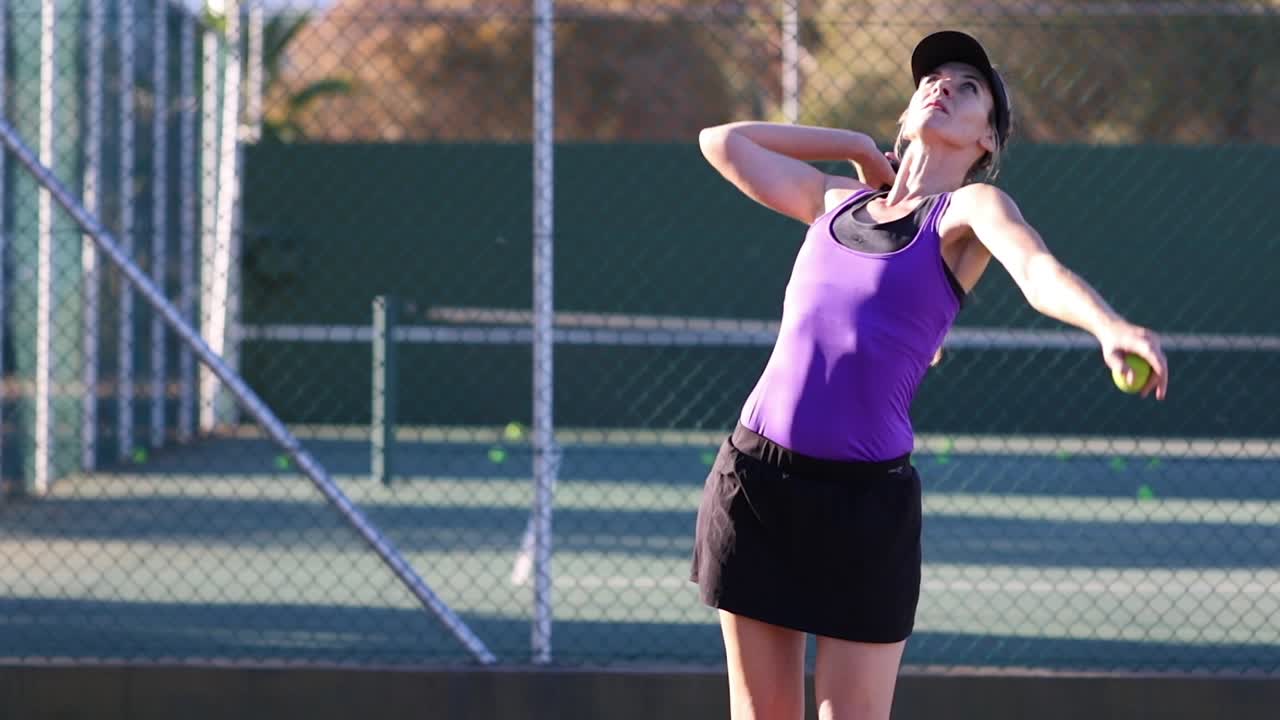 테니스 코트에서 테니스를 치는 여성 테니스 선수의 영상을 클로즈업하세요