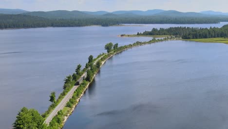 drone shot of a train going north through the adirondack park in upstate new york