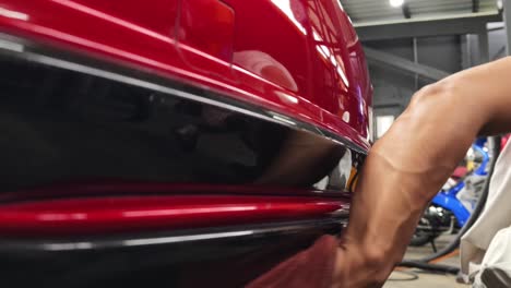 red car detailing in a garage