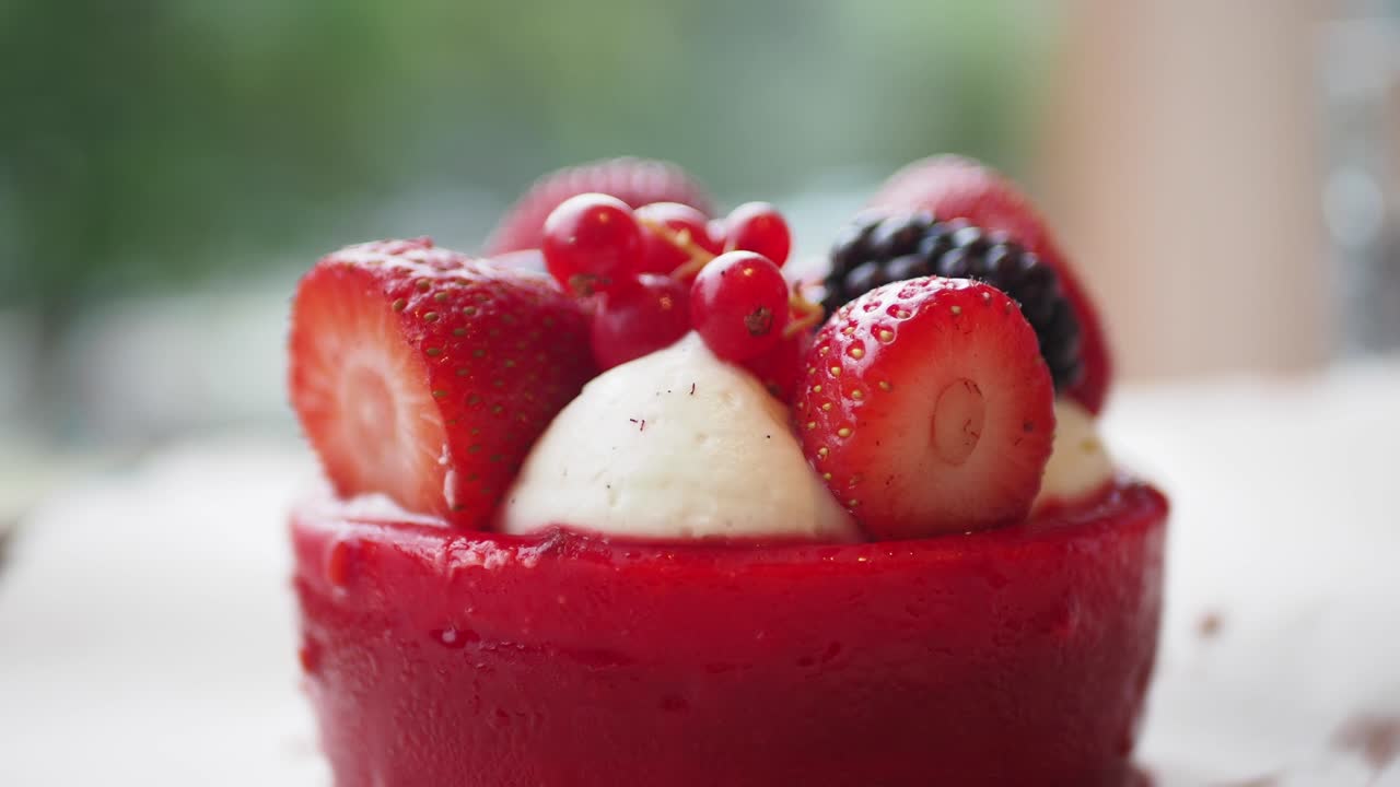 Close-up of a small strawberry dessert with whipped cream