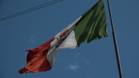 Mexican-flag-waving-in-a-blue-sky