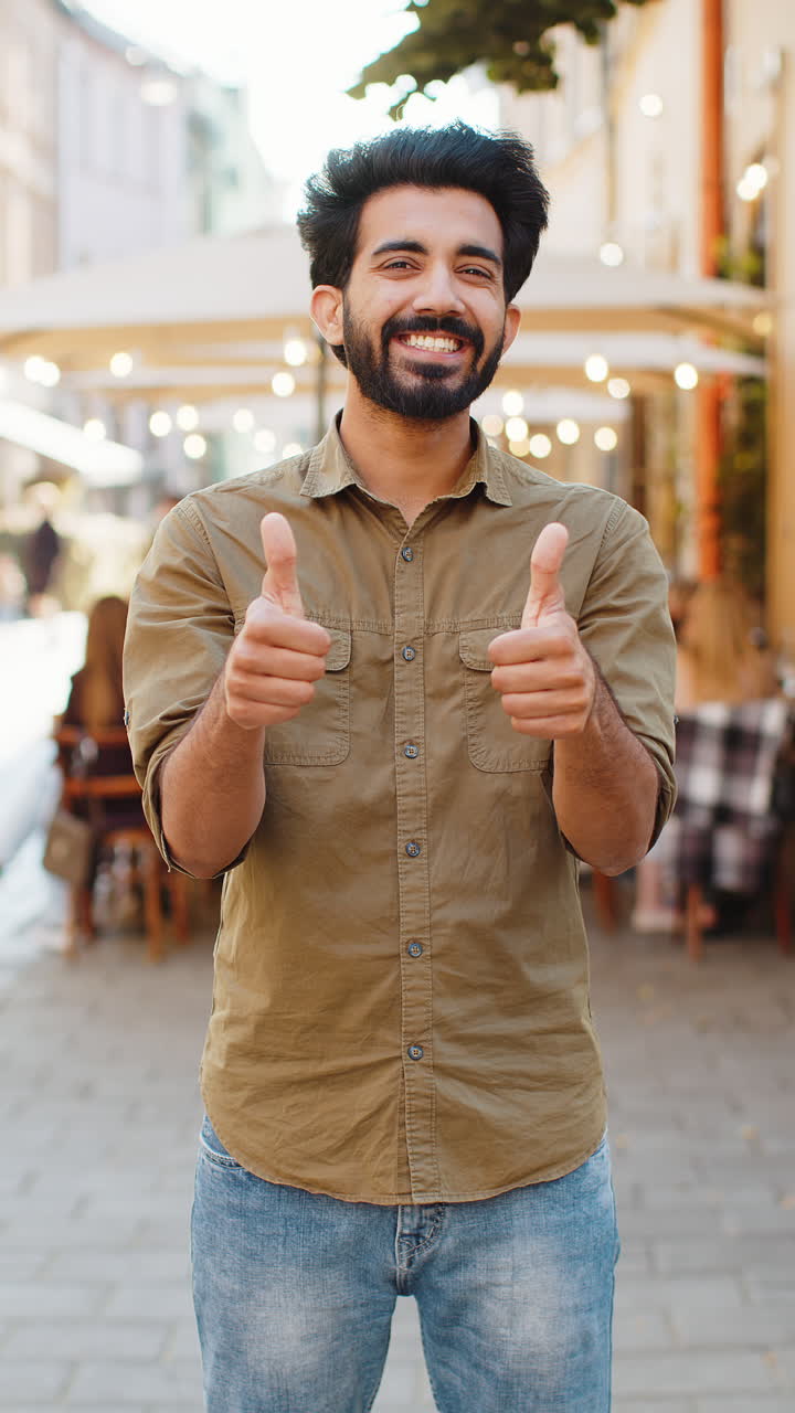 Happy man showing thumbs up like sign positive something good positive feedback in city street