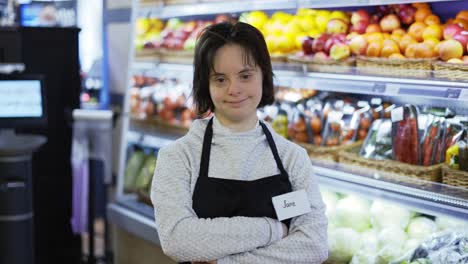 portrait of a shot worker with down syndrome standing with crossed hands at shot