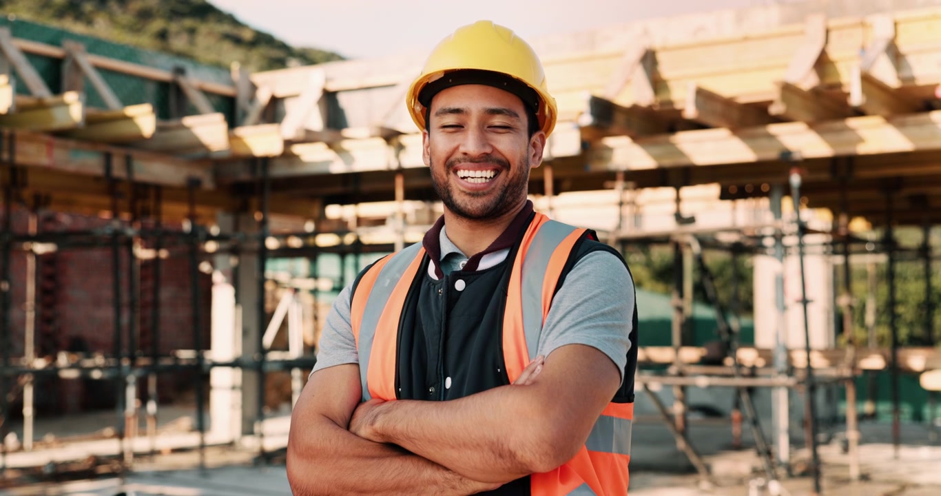 Portrait of a Smiling Construction Worker at a Building Site