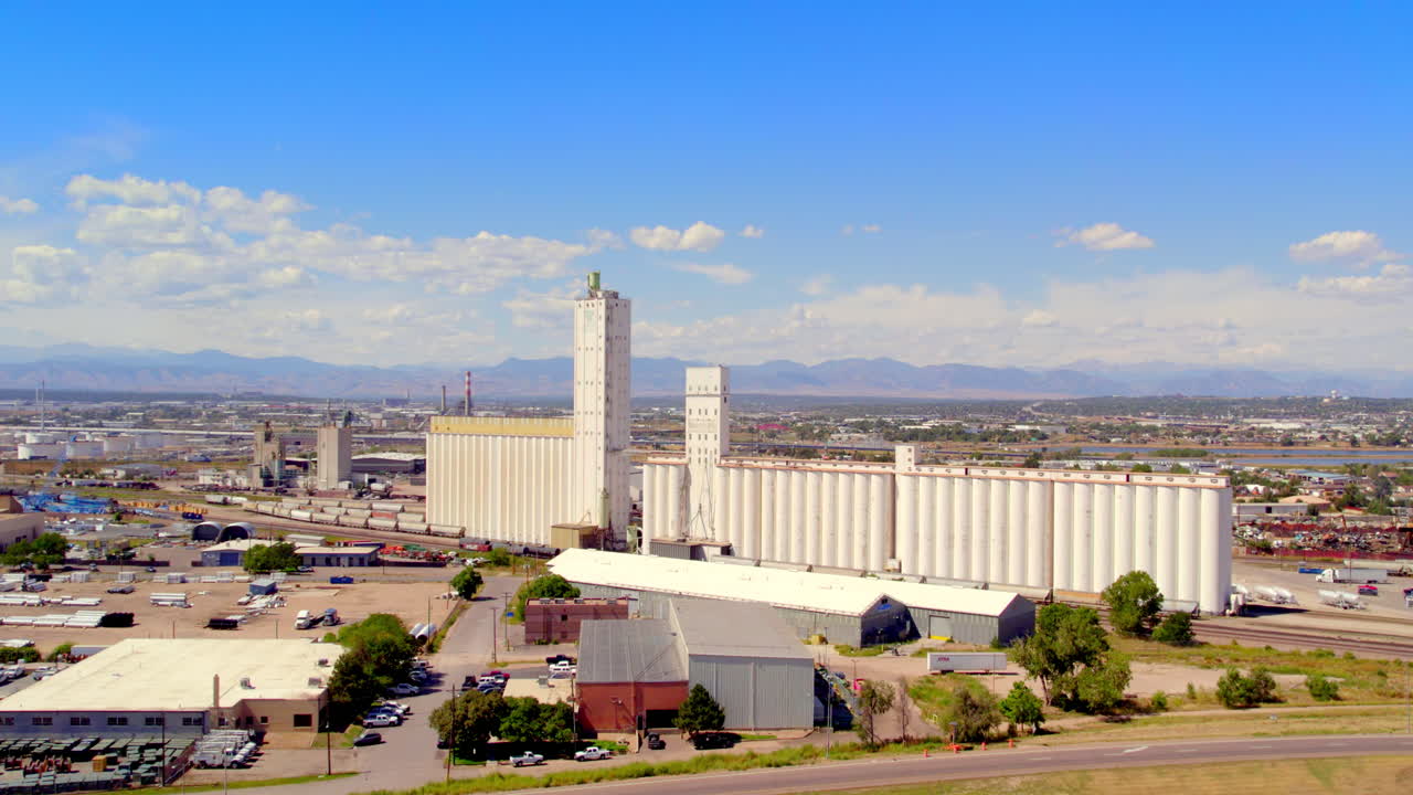 Fly towards old factory in front of Rocky Mountains
