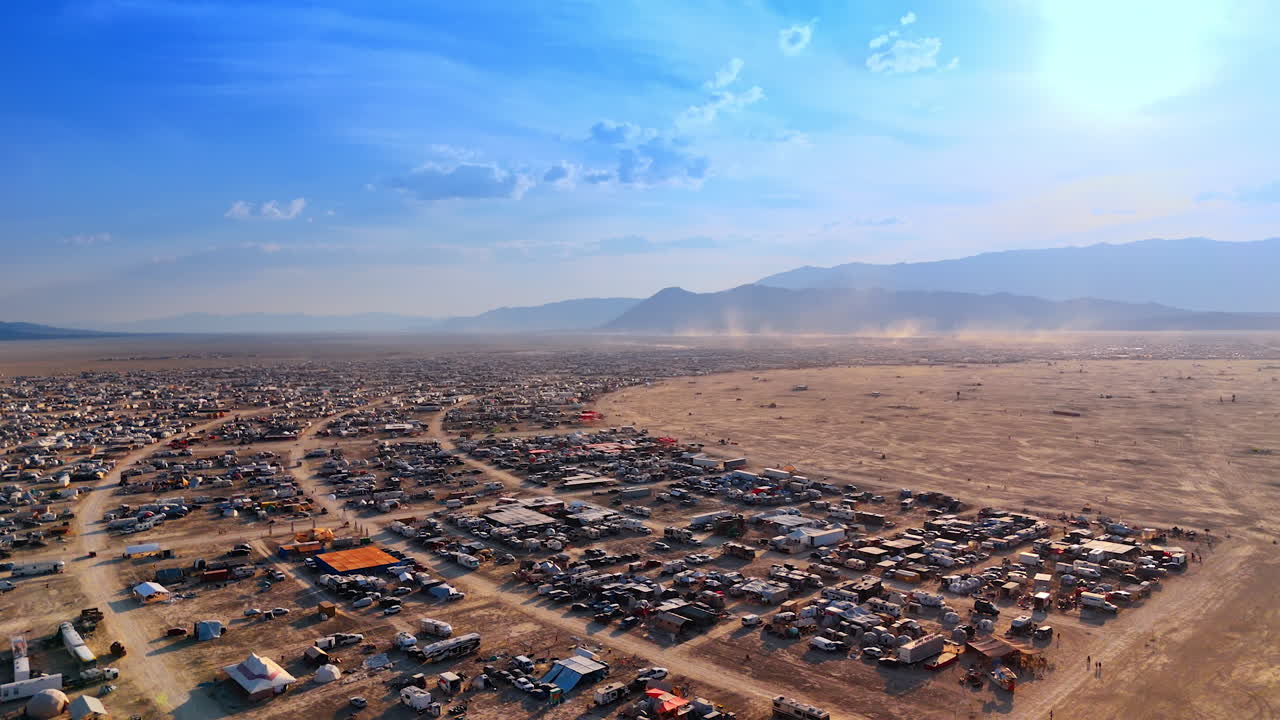 Enormous circle-shaped camp of the Burning Man festival. Drone footage above the Black Rock Desert at daytime