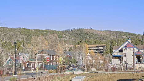 tourists and cyclists moving through the downtown area of breckenridge, colorado in the fall