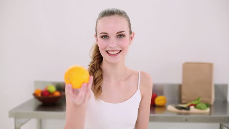 smiling model smelling an orange