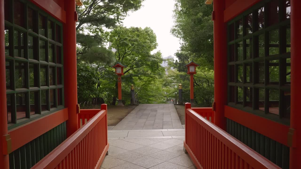 Stunning slow motion walk through red torii gate in Japanese shrine