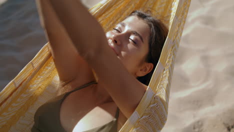 calm girl lying hammock in sunlight closeup. carefree beautiful woman relaxing