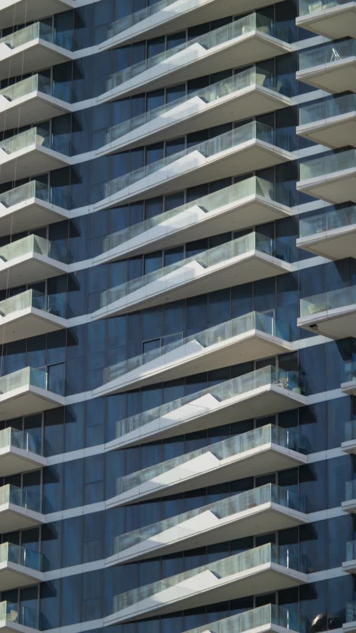 Modern Glass High-Rise Building Facade with Balconies