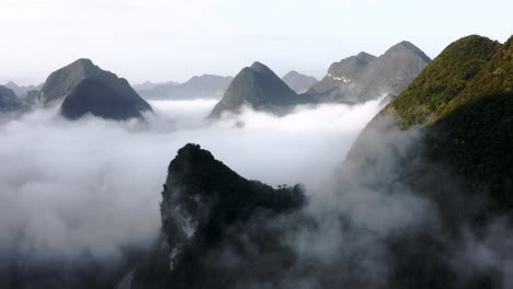 Beautiful-cloudy-karst-mountains-in-Asia,-dramatic-aerial-view