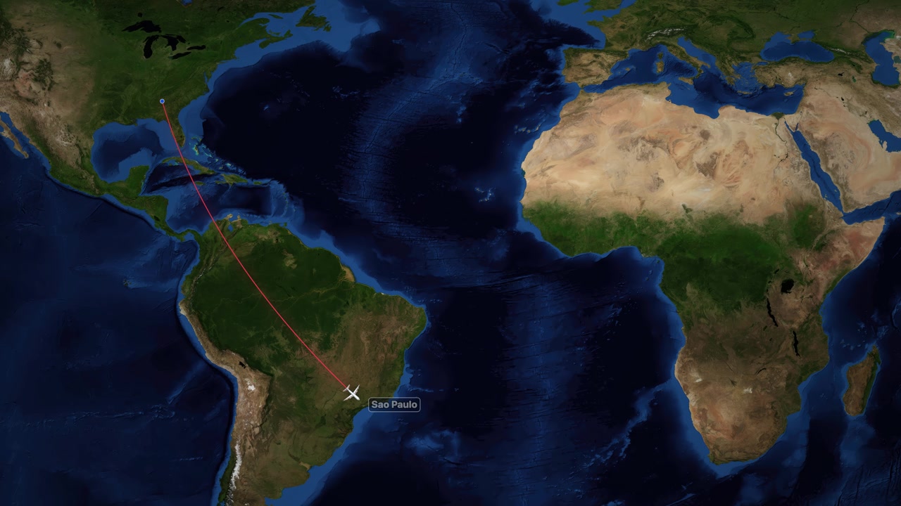 Animazione digitale che traccia una rotta di volo da Atlanta a San Paolo su una mappa del mondo.