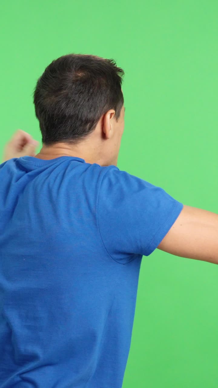 Rear view of a man waving a thai pennant