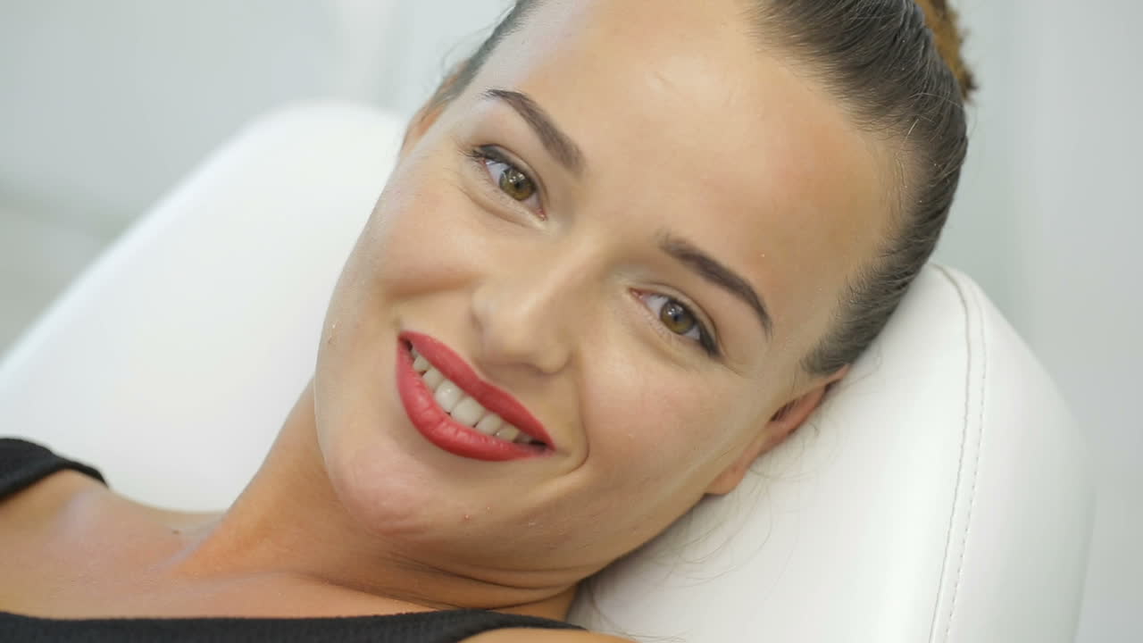 Woman with permanent makeup looking at the camera and smiling