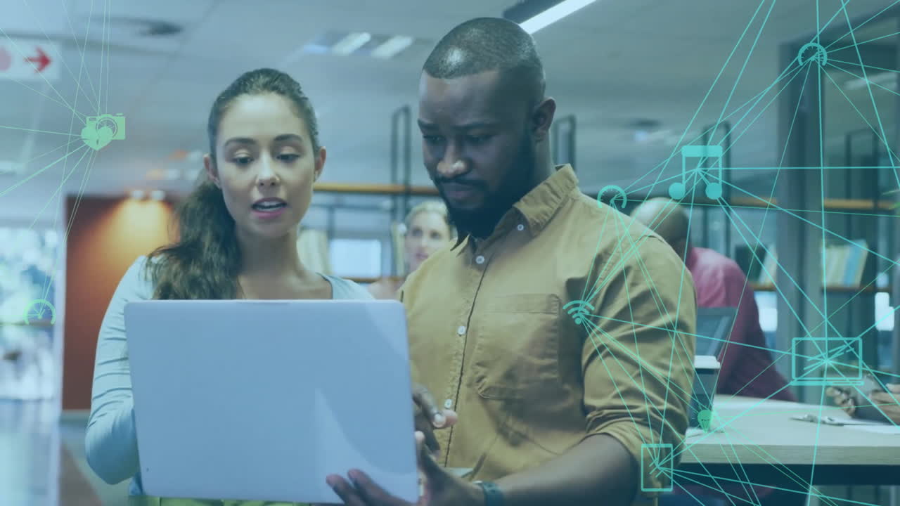 Animation of financial data processing over diverse business people using laptop in office