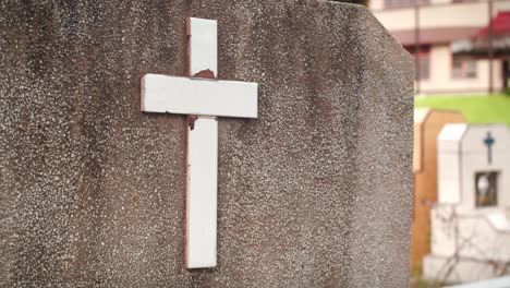 Cross-on-stone-tombstone-in-Christian-cemetery-of-Medan,-Sumatra