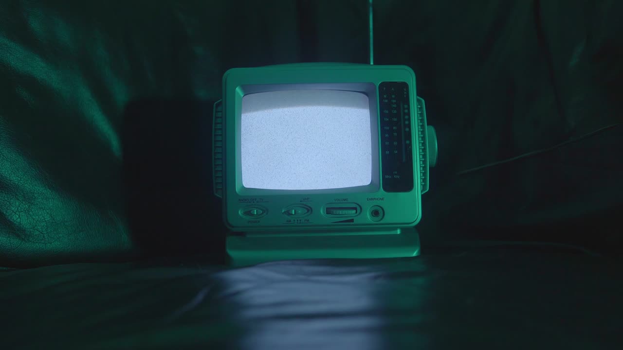 A vintage TV in a dimly lit room, evoking a nostalgic, retro atmosphere. The soft lighting and faded colors create a moody, cinematic vibe.