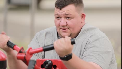 man dos ehertzises on sports car ehertzise vgich is n park exercise in a public park weight loss man dos ehertzises on sports car ehertzise vgich is n park exercise in a public park weight loss active lifestyle concept