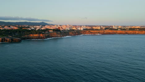 aerial view coastal resort town with calm ocean. building complex on stone cliff