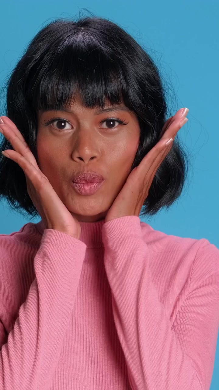 Shocked southeast asian woman expressing surprise with open mouth on camera