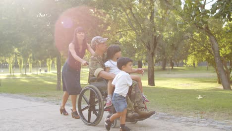 disabled soldier walking with kids and wife