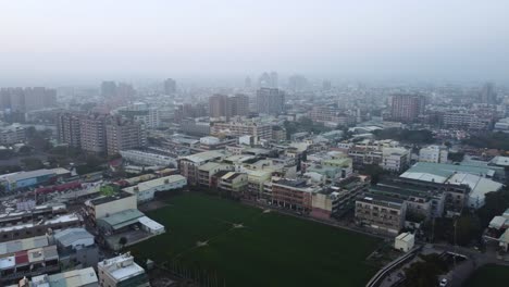 a dense cityscape at dusk with soft light, hinting at urban life, aerial view