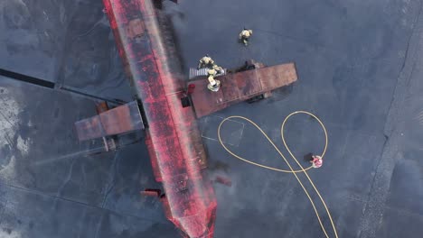 Firemen-exiting-dummy-aircraft-via-wing-during-fire-exercise-at-airport