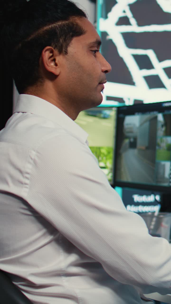 Man Monitoring Traffic Surveillance Footage on Multiple Computer Screens