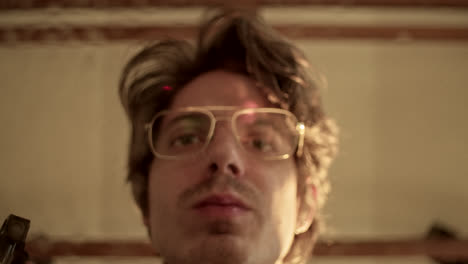 hazy close-up portrait of a man wearing glasses