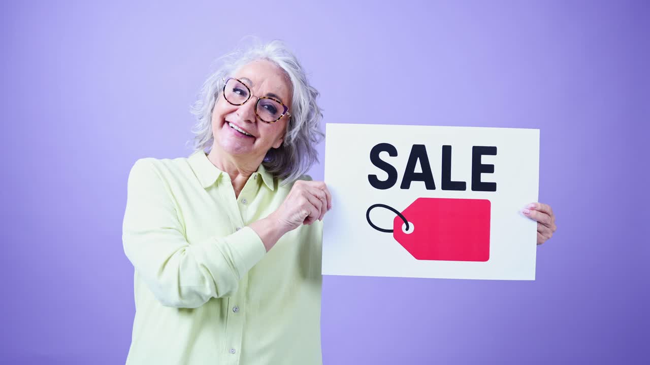 Donna anziana felice che tiene un cartello di promozione saldi
