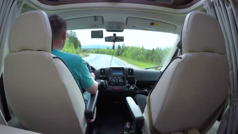 Man-driving-on-a-road-in-the-Camper-Van-RV