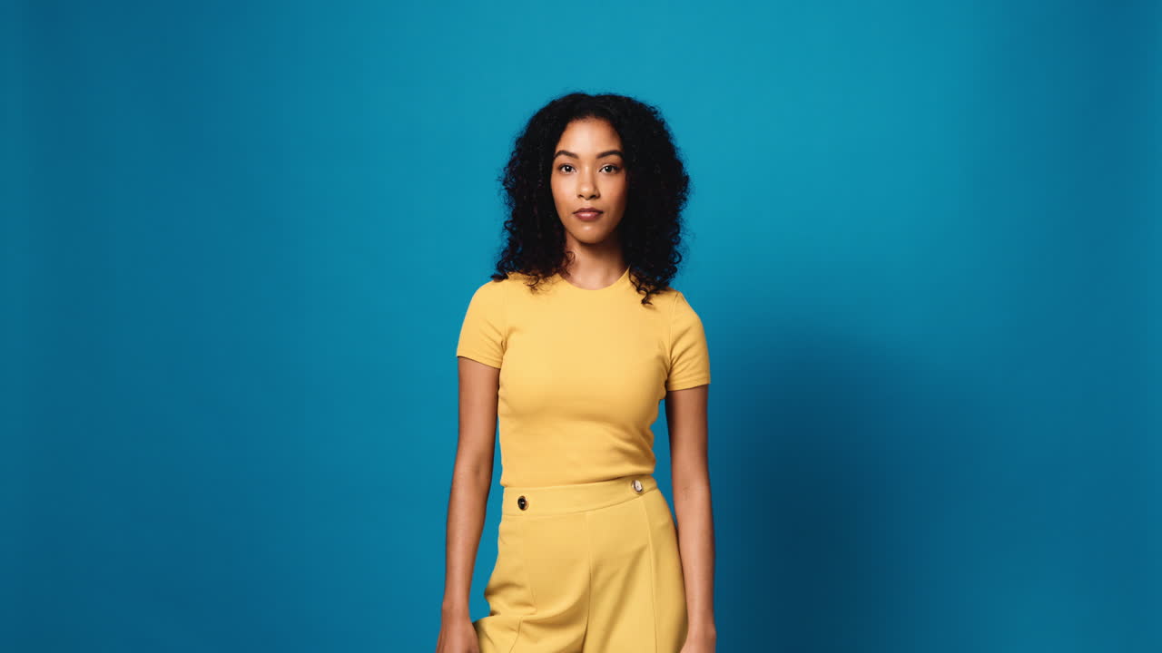 Excited Woman Pointing Upward on Blue Background