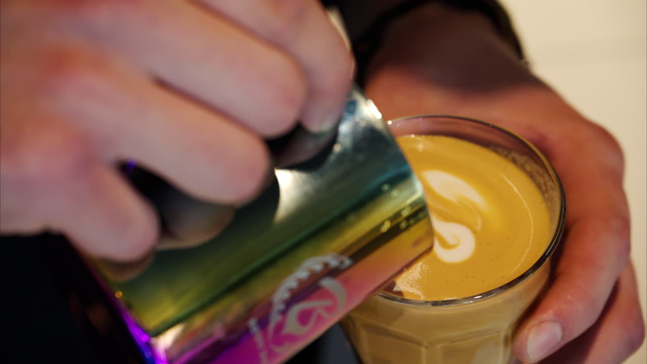 Barista foaming the milk at a coffee shop