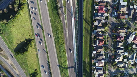 Perspectiva-De-Seguimiento-Suave-Desde-El-Dron-Mirando-De-Arriba-Hacia-Abajo-En-El-Cruce-De-Carreteras-Ocupado-Debajo